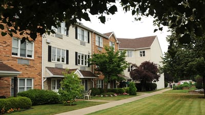 Exterior view of The Village House with landscaped area