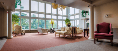 Bright common area with large windows and seating