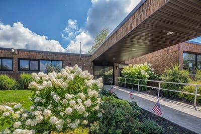 Entrance of the Alpine Rehabilitation and Nursing Center with flowers