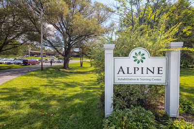 Exterior view of Alpine Rehabilitation & Nursing Center sign