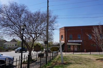Exterior view of a brick building with signage