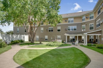 Exterior view of an assisted living facility with landscaping
