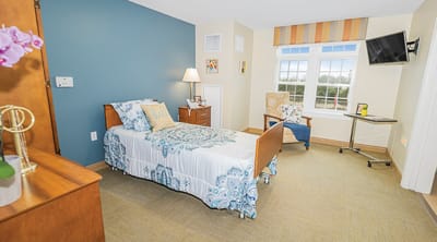 Cozy resident room with a bed and chair