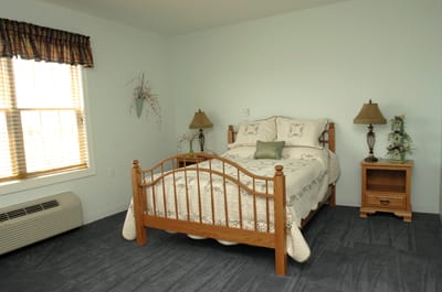Cozy private bedroom with a floral bedspread