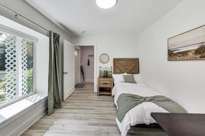 Bright interior bedroom with a bed and window view