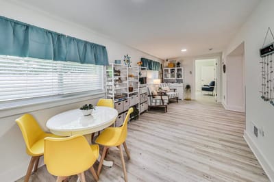 Bright common area with yellow chairs and natural light