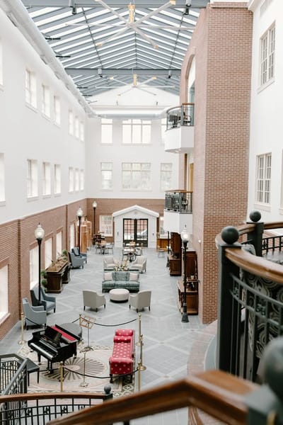 Bright common area with seating and piano