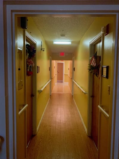 Bright hallway with yellow walls and decorated doors