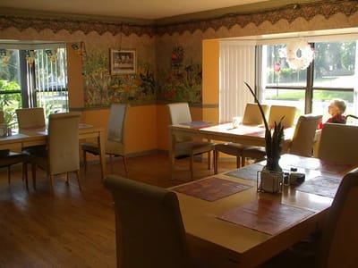 Interior dining area with tables and a resident