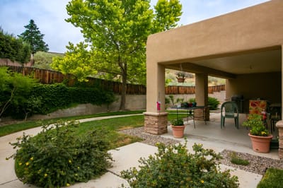 Outdoor patio area with seating and greenery