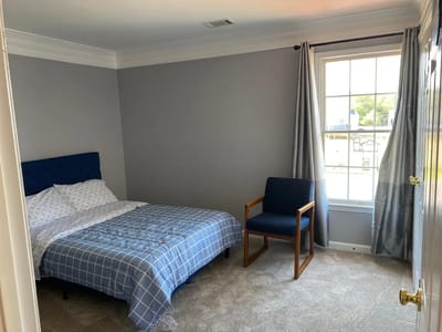 Cozy resident room with bed and chair