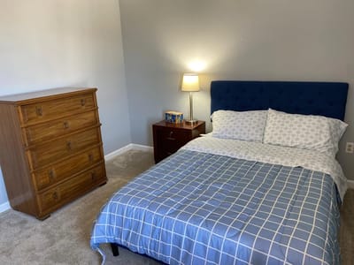 Cozy bedroom setup with a blue bedspread