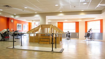 Interior view of a therapy room with exercise equipment