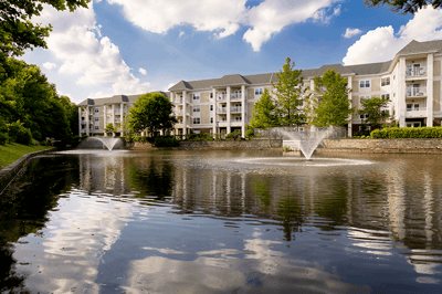 Beautiful exterior view of the facility by a pond