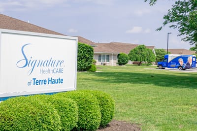 Exterior view of Signature Healthcare facility with a transport van