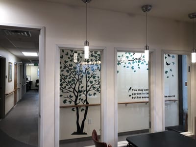 Interior view with tree mural and text on wall