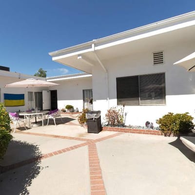 Outdoor area with seating and tables near the facility.