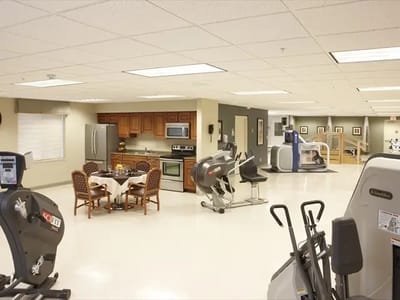 Well-equipped fitness area with kitchen and dining table