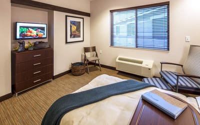 Well-furnished resident room with TV and window