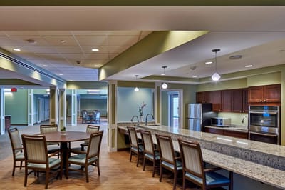 Interior view of a communal area with seating and kitchen