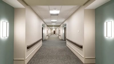 A well-lit hallway in a senior living facility