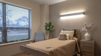 A cozy resident room with a bed and window