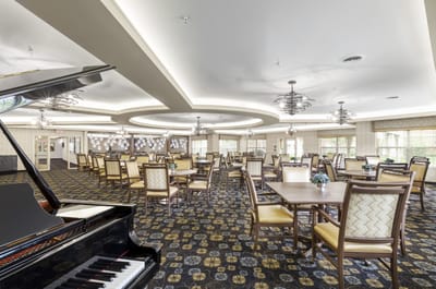 Elegant dining room with piano and seating