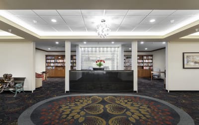 Lobby area with reception desk and bookshelves