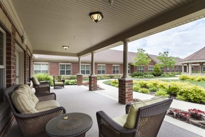 Outdoor seating area with comfortable chairs and greenery