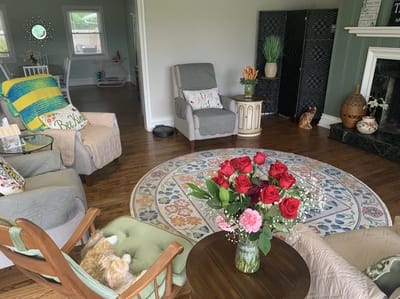 Cozy interior common area with seating and flowers