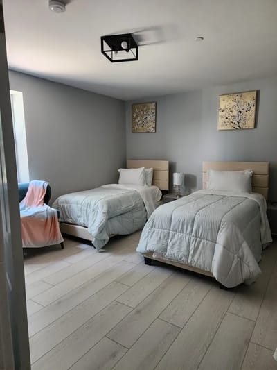 Two twin beds in a shared room with light decor