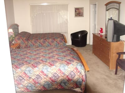 Cozy shared bedroom with two beds and furniture.