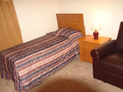 Cozy bedroom with a single bed and nightstand.
