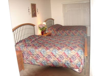 A cozy shared resident room with two beds.
