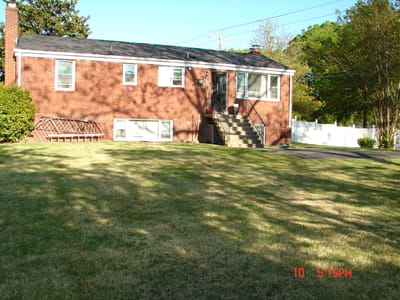 Exterior view of a brick building with grass lawn.