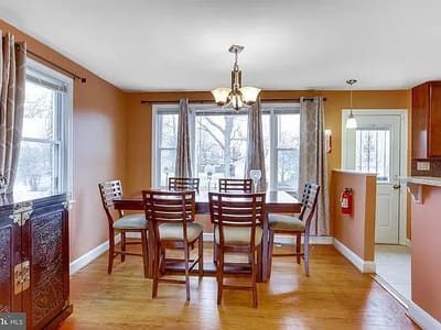 Bright dining area with wooden chairs and table