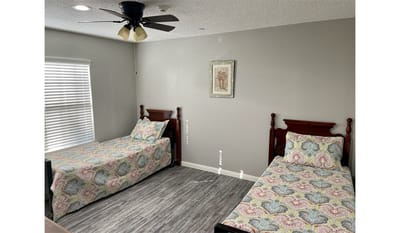 Bright, inviting bedroom with two beds.