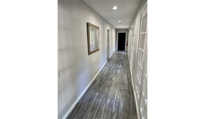 Well-lit interior hallway in assisted living facility.