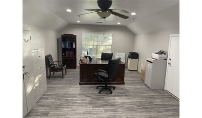 Office space with desk and filing cabinets.
