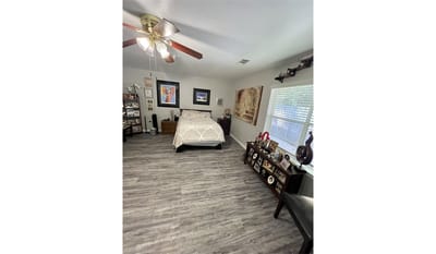 Cozy bedroom with personal decor and photos.
