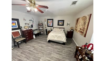Cozy bedroom with personal decor and furniture.