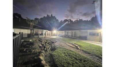 Exterior view of a facility at night.