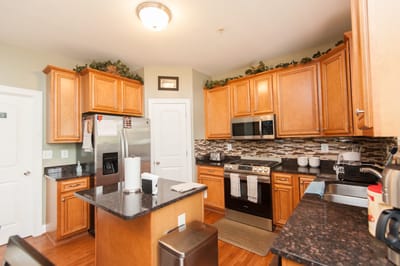 Bright kitchen area with wooden cabinets and modern appliances