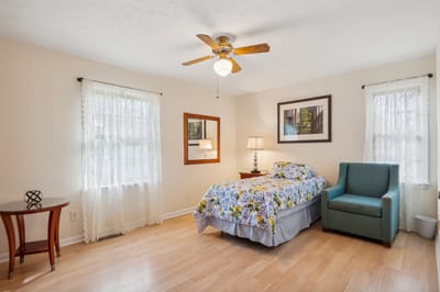 Cozy resident room with floral bedding and natural light