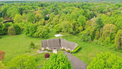 Aerial view of a large assisted living facility surrounded by greenery