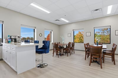 Bright interior dining room with windows and tables