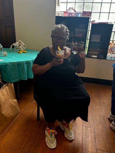 A resident enjoying a drink in a facility interior