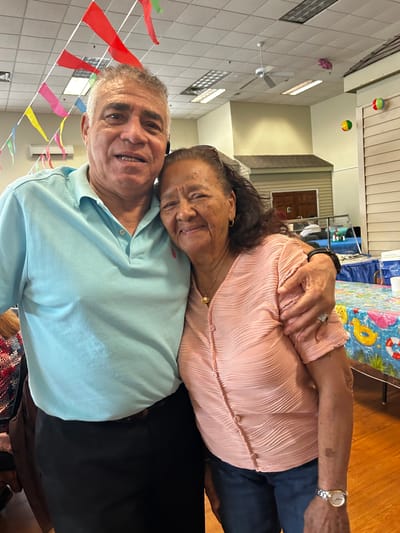 Two residents smiling together in a common area