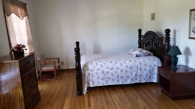 A cozy resident room with a bed and furniture.