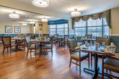 Dining room setup with tables and chairs.